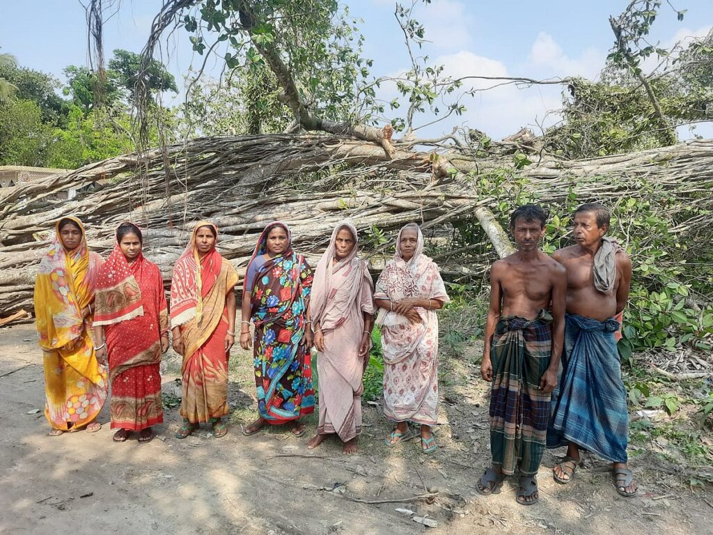 Residents tearful in front of the banyan tree which commemorates the poet Madhusudan