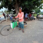 Defrauded by labor brokers, Bangladeshi cyclist keeps family afloat with door-to-door egg trade