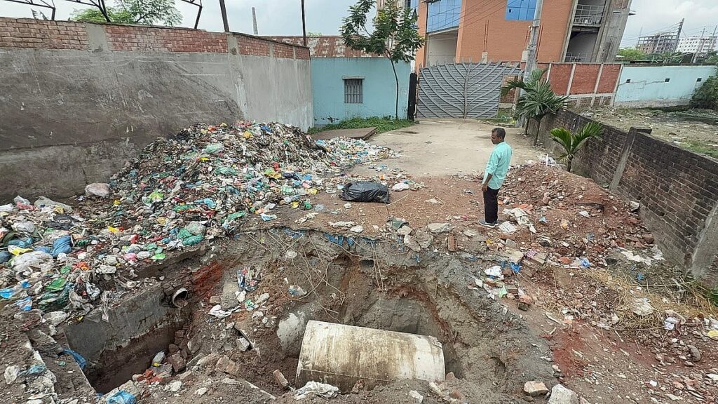 Dhaka North City Corporation excavates road in front of factory following official standoff
